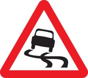 slippery road ahead road sign